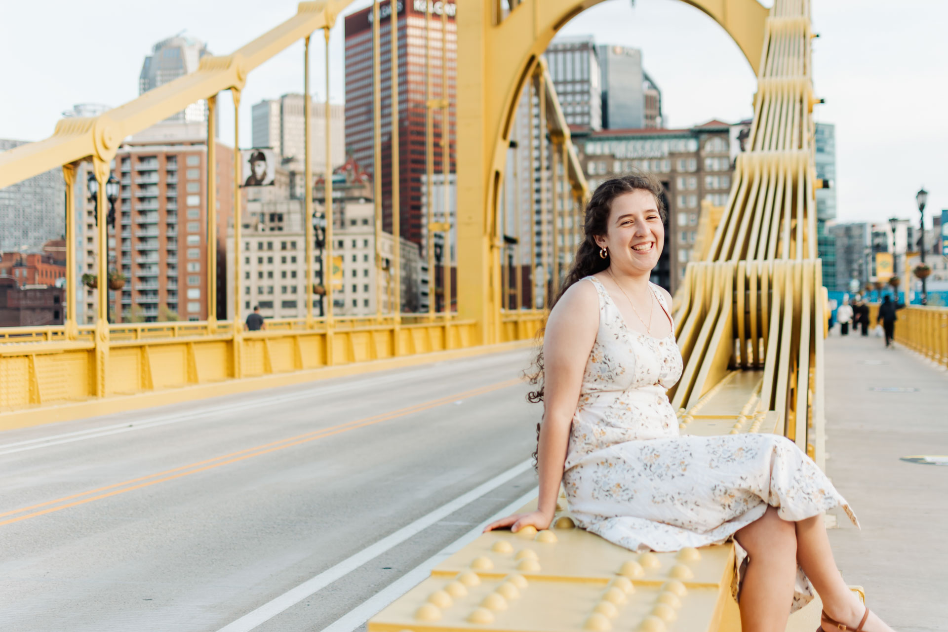 Senior portrait in golden-hour light at the Roberto Clemente Bridge in Pittsburgh